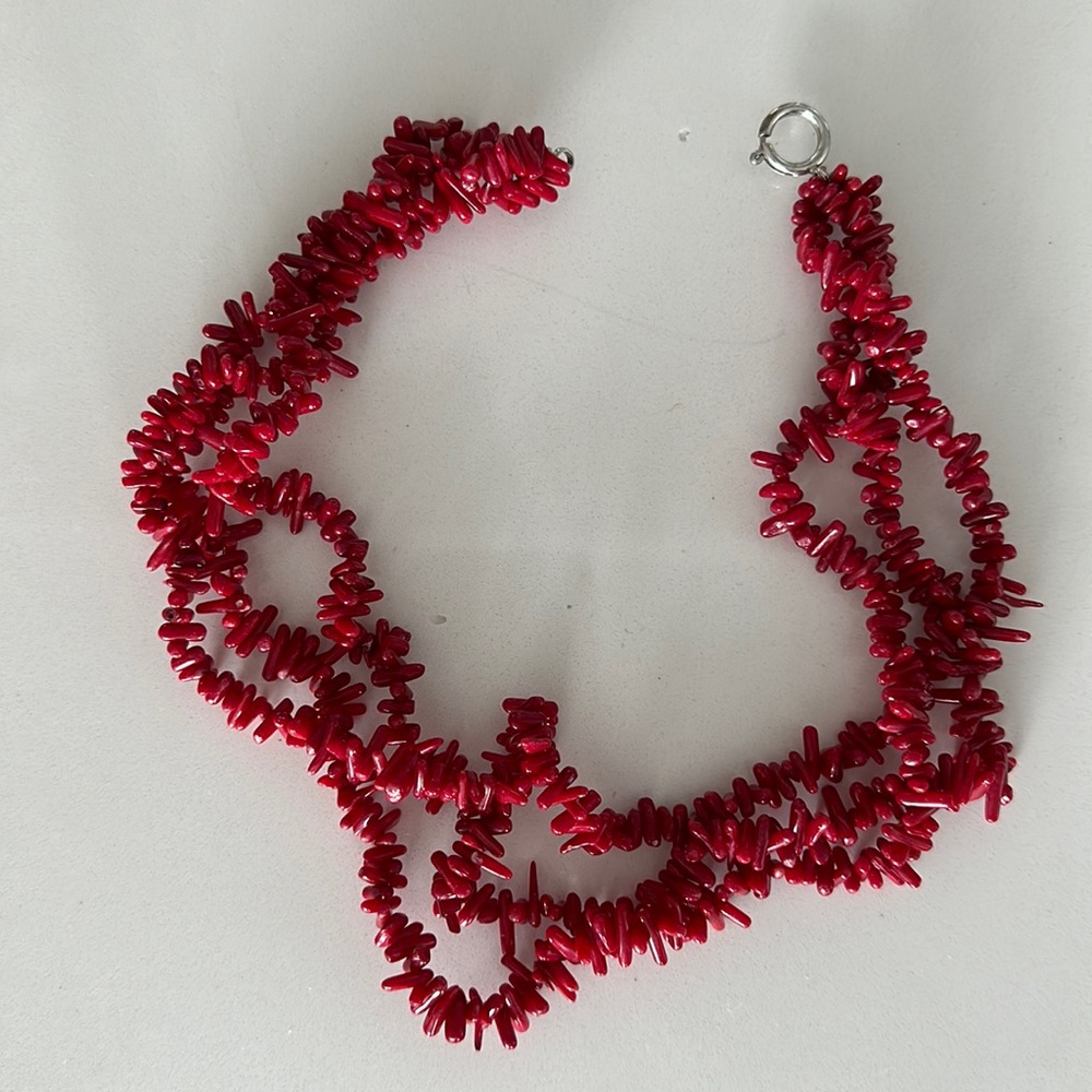 Red beaded necklace (sits around collarbone)